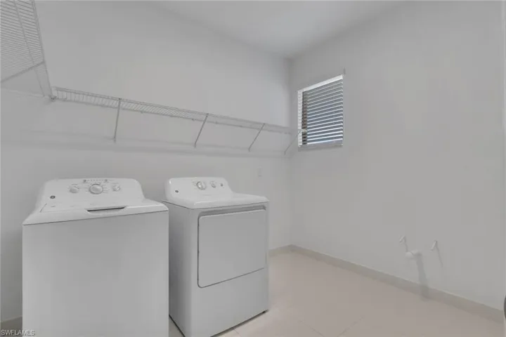 Spacious laundry room pre-plumbed for a utility sink.