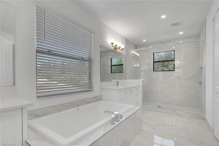 Primary bath features Roman tub and separate shower.