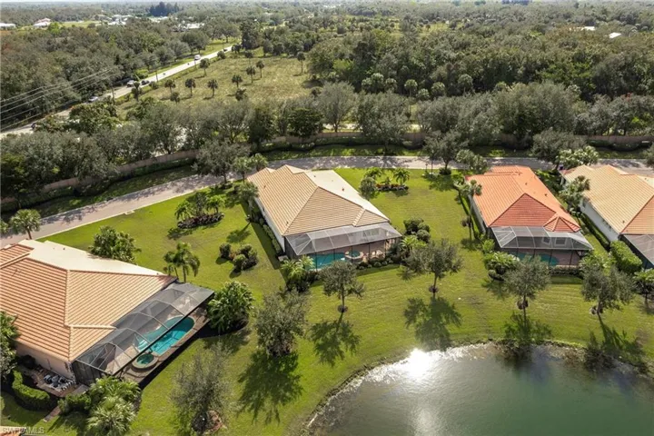 Aerial view featuring the lake in the rear of the home.