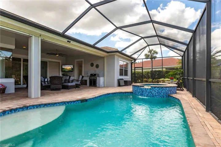 Large under roof lanai, heated pool/spa, outdoor kitchen and half bath are all features of this exceptional home.