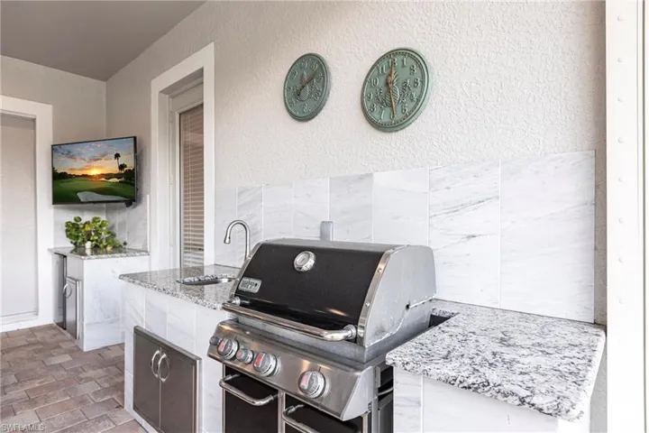 Outdoor kitchen with granite countertops hooked directly to natural Gas.