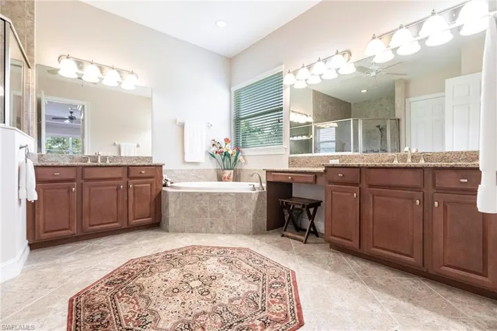Bathroom dual sinks, vanity, and independent shower and tub