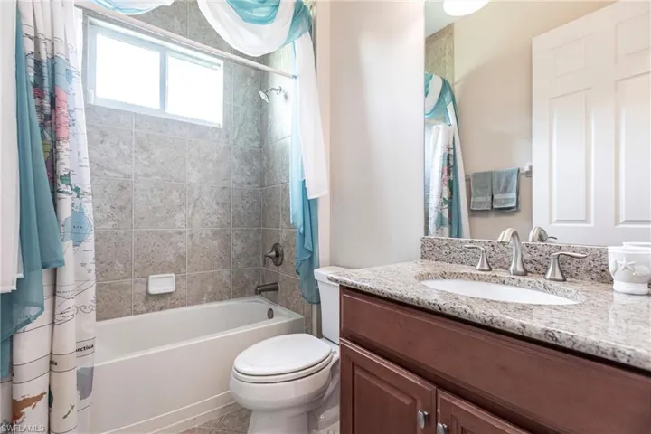 Full bathroom with tile patterned floors and shower/tub combo