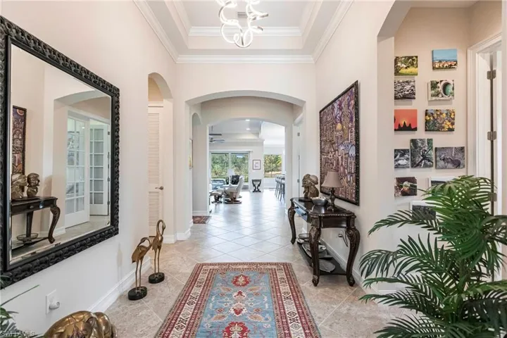 Large Foyer entrance featuring upgrade lighting, crown molding and diagonal tile