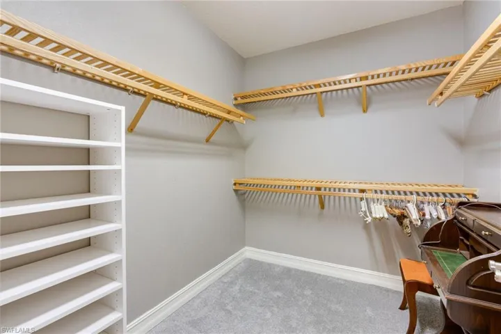 Walk in closet featuring light carpet