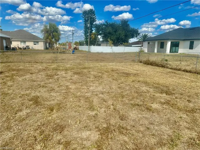 Fenced backyard with a playground