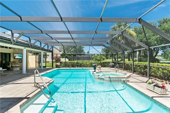 View of pool with an in ground hot tub, a patio, and a lanai