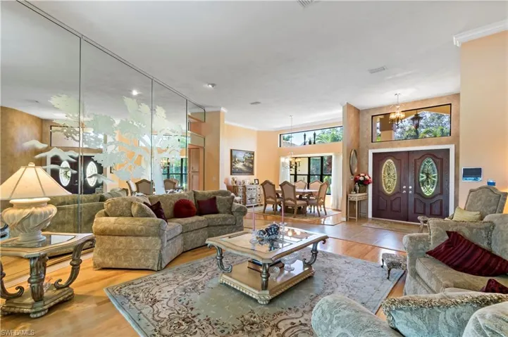 Living room with an inviting chandelier and hardwood / wood-style floors