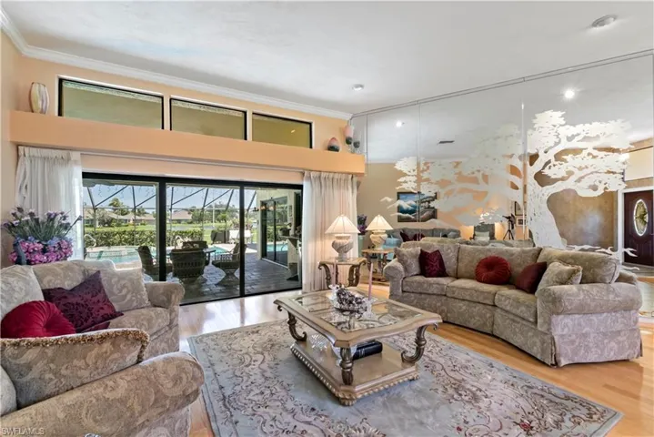 Living room featuring crown molding and hardwood / wood-style floors