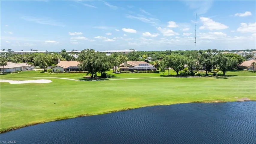 Surrounding community with a yard and a water view