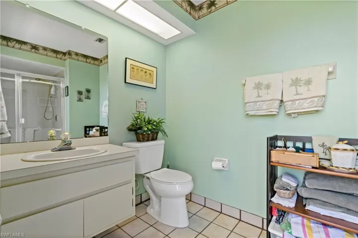 Bathroom featuring tile floors, vanity, and toilet