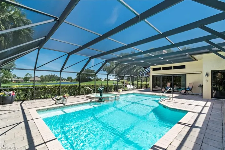 View of swimming pool with an in ground hot tub, a patio, and a lanai