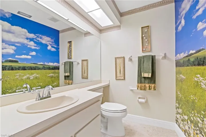 Bathroom featuring tile floors, large vanity, and toilet