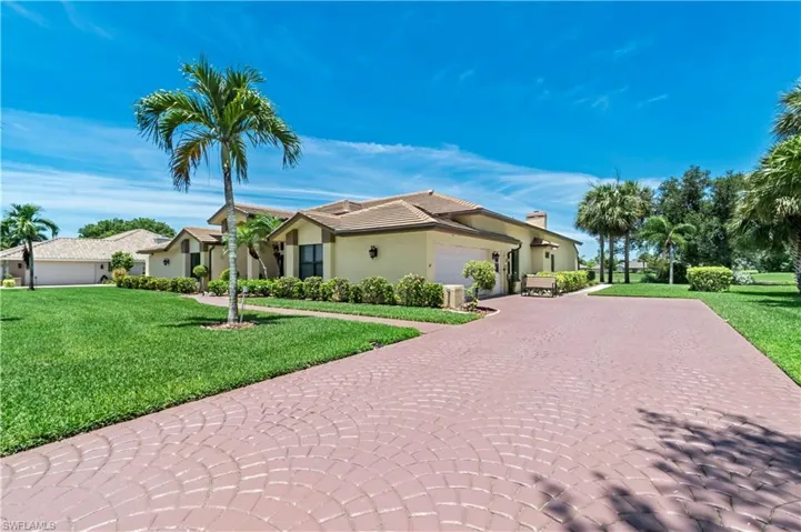 View of front of home with a front lawn and a garage