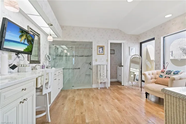Bathroom featuring an enclosed shower, hardwood / wood-style flooring, and vanity