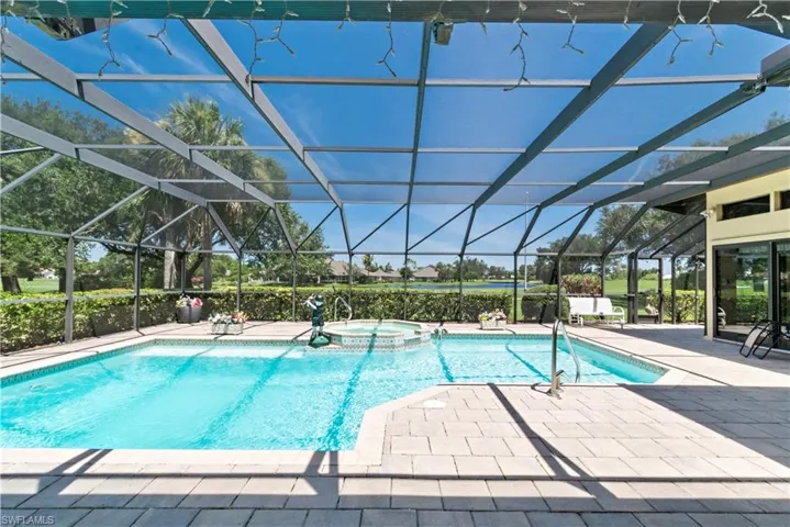 View of pool featuring a patio area, a lanai, and an in ground hot tub