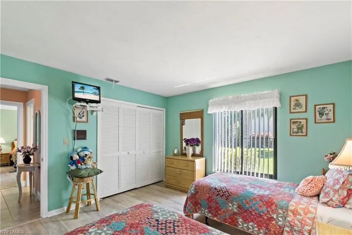 Tiled bedroom featuring a closet