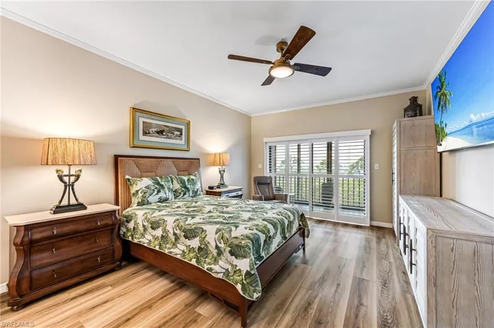 Bedroom featuring crown molding, access to outside, hardwood / wood-style floors, and ceiling fan
