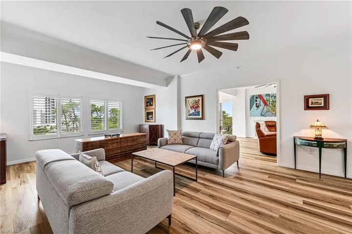 Living room featuring hardwood / wood-style floors and ceiling fan