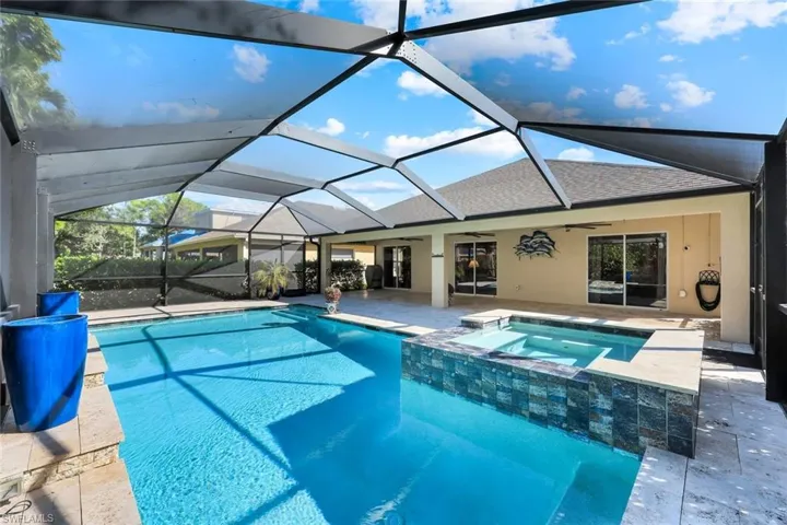 View of swimming pool featuring a patio area, a ceiling fan, a sunroom, a lanai, and a pool with connected hot tub