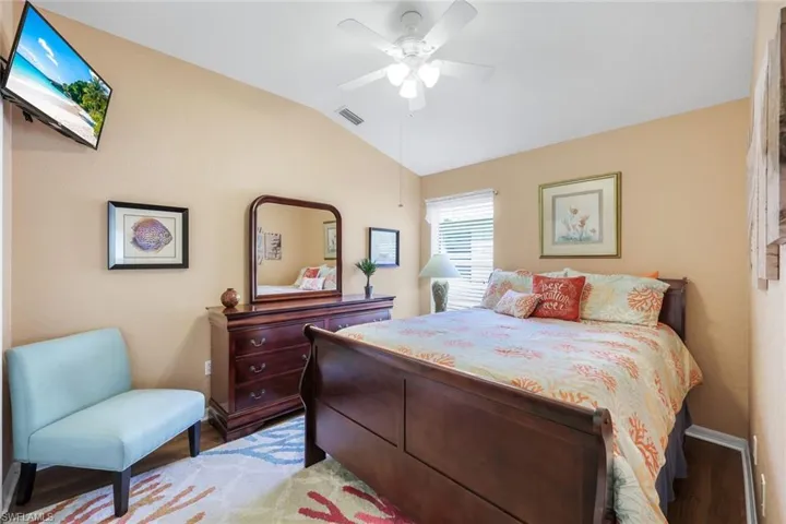 2nd Bedroom featuring lofted ceiling, laminate floors, and a ceiling fan