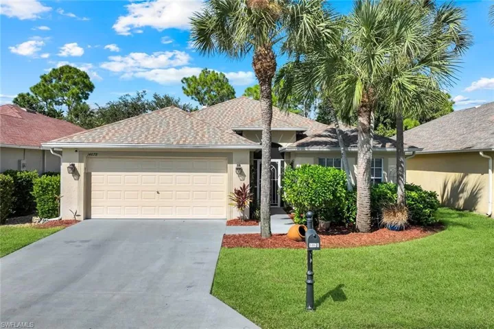Ranch-style house with stucco siding, concrete driveway, an attached garage, and a front lawn