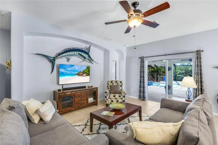 Living area featuring tile floors and a ceiling fan