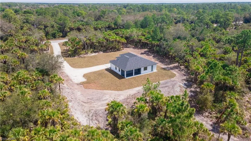 View of subject property with a heavily wooded area