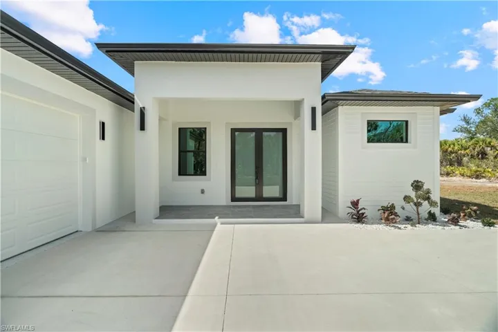 Rear view of house featuring french doors and a patio area