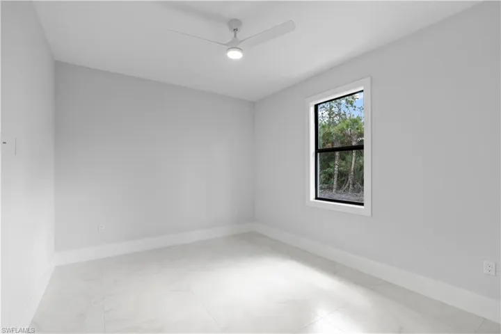 Spare room with baseboards and ceiling fan