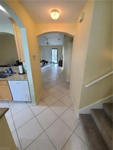 From entryway, inward. Kitchen to left, stairs to right, great room straight ahead.