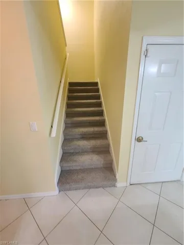 Carpeted steps leading to upstairs bedrooms