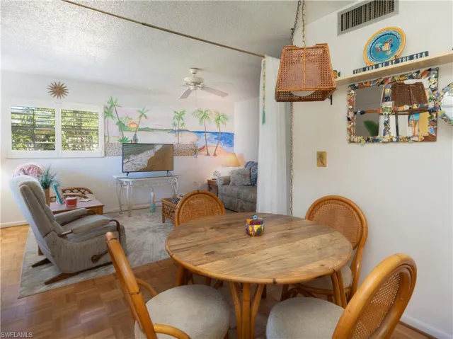 Dining room featuring a textured ceiling and a ceiling fan