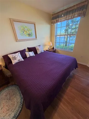 Bedroom with wood finished floors and baseboards