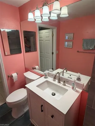 Bathroom with vanity and dark tile patterned floors