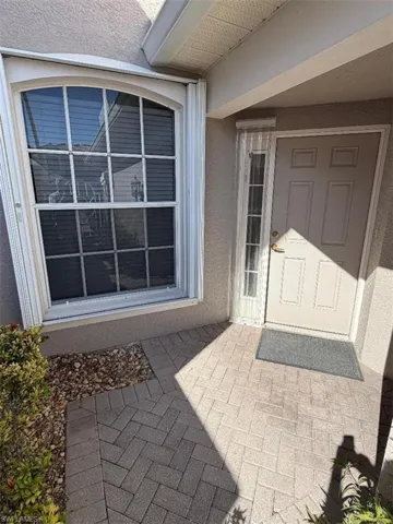 Doorway to property with stucco siding