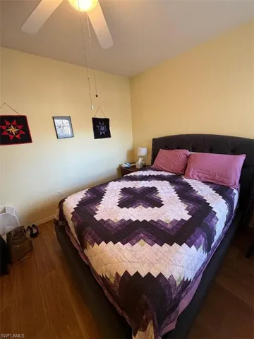 Bedroom featuring wood finished floors and a ceiling fan