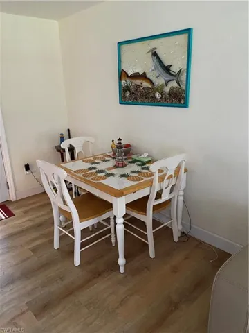 Dining area with wood-type flooring