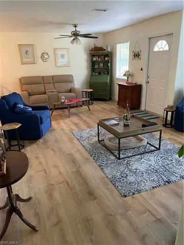 Living room featuring light hardwood / wood-style floors and ceiling fan