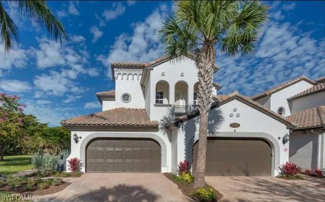 Mediterranean / spanish-style house featuring stucco siding, decorative driveway, and a tile roof