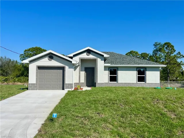Ranch-style home with a garage and a front yard