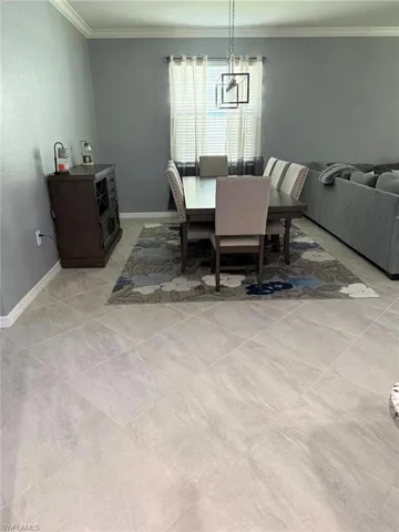 Dining space featuring ornamental molding