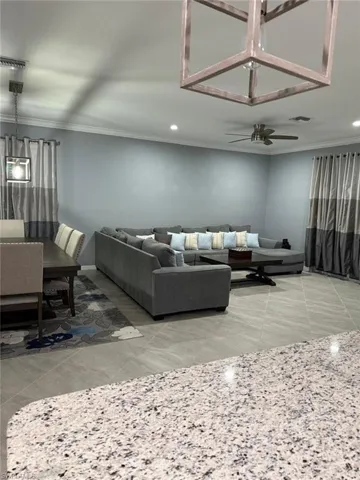 Living room with crown molding and recessed lighting