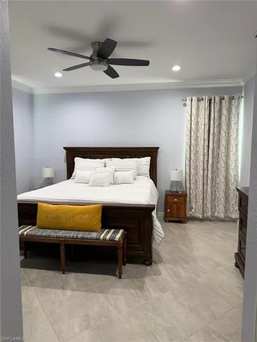 Bedroom featuring ornamental molding and ceiling fan