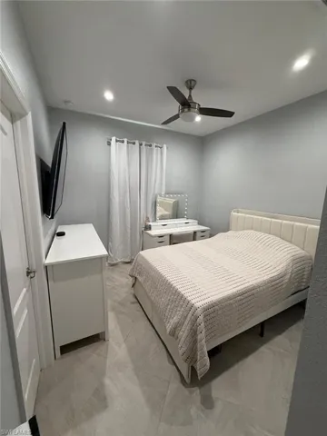 Bedroom with ceiling fan and recessed lighting