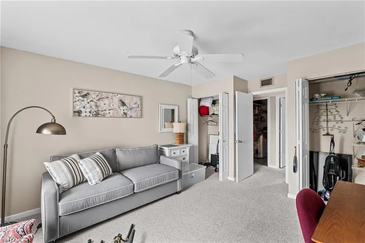 Living area with carpet and ceiling fan