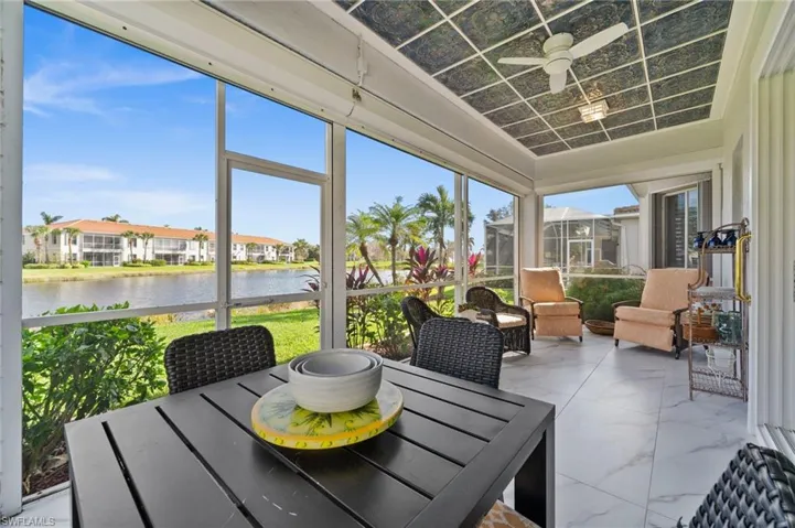 Sunroom featuring ceiling fan, a healthy amount of sunlight, and a water view