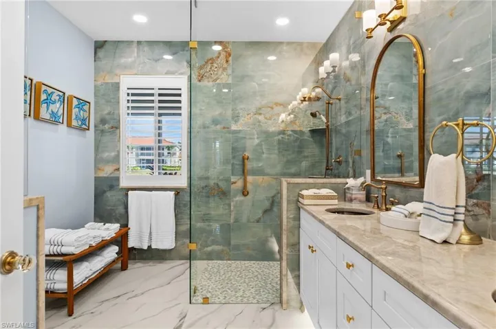 Bathroom featuring tile walls and a tile shower