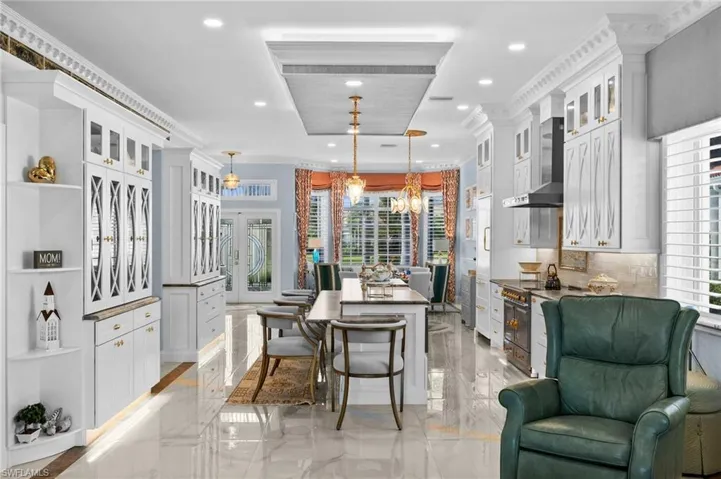 Dining space with a chandelier, plenty of natural light, and crown molding