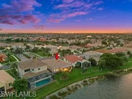 Aerial view at dusk featuring a water view
